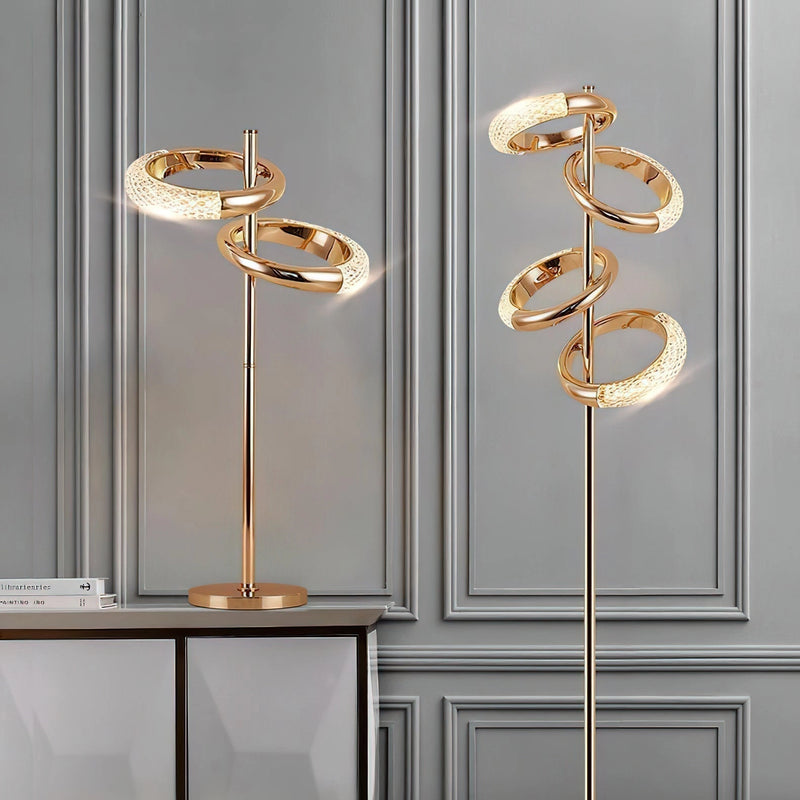 Gold diamond-patterned adjustable angles floor lamp with amber lighting, featuring a wooden base and rectangular accents against a wall.