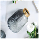 Green glass vase designed for hydroponic plants featuring a sleek, Nordic aesthetic.