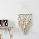Handwoven Macrame Boho wall hanging tapestry featuring geometric art decor, displayed on a wood shelf with metal and twig accents.