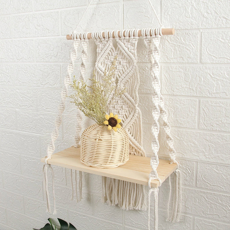 Handwoven macrame boho wall hanging tapestry featuring geometric art decor, displayed above a wooden table with decorative twigs and natural ornaments.