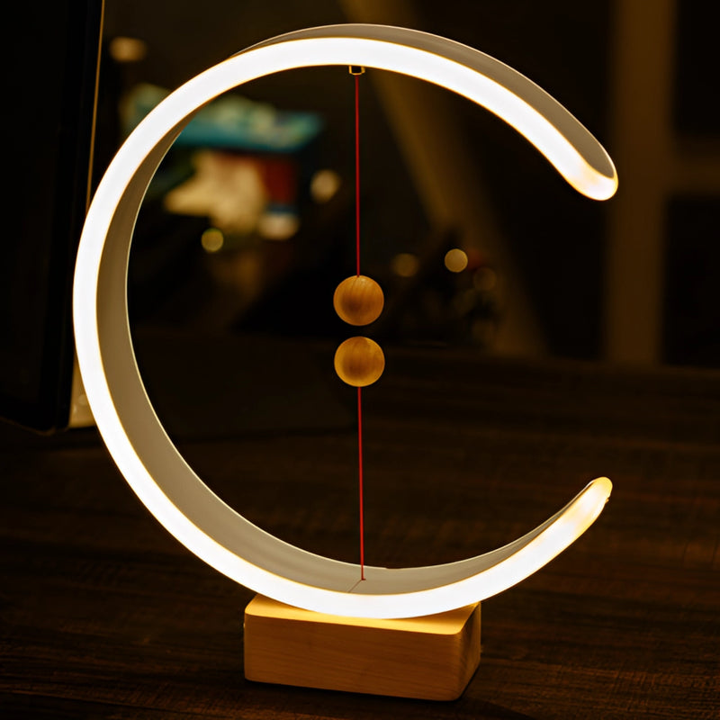 Wooden and metal interior lamp featuring crescent-shaped glow, magnetic switches, displayed with artistic tints and shades in a circular and rectangular design.