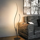 Modern interior lamp made of metal and wood, featuring adjustable temperatures, placed near a window with artistic tints and shades on the flooring.