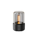 LED aromatherapy diffuser designed to mimic a candle light effect, featuring a cylindrical shape with a metallic finish and a central illuminated area that emits a soothing glow.