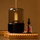Black LED aromatherapy diffuser with candle light effect, featuring a USB connector, displayed as a sleek glass bottle design with a wooden cap.
