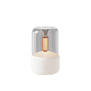 Beige LED aromatherapy diffuser with candle light effect, featuring a cylindrical metal body and USB connectivity.