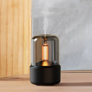 LED aromatherapy diffuser with candle light effect, featuring a cylindrical shape and metallic finish with shades of grey.