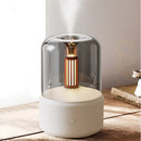 LED aromatherapy diffuser with a candle light effect, featuring a cylindrical metal body and designed to resemble a kitchen appliance.