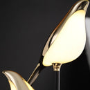 Postmodern LED desk lamp featuring a galvanized golden bird design with detailed beak and feathers, set against a wood-inspired base.