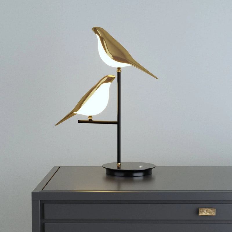 Artistic LED desk lamp featuring a postmodern galvanized golden bird design, crafted from metal and plywood, with a seabird sculpture balanced at the base.