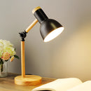 Black LED desk lamp with Scandinavian minimalist design, featuring a three-color switch, displayed against a wooden background with a decorative orange rose.