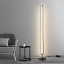 Stylish LED floor lamp featuring RGB multicolor and warm white lighting settings, positioned on a wooden floor near a chair, enhancing a cozy and comfortable ambiance.