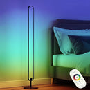 Stylish LED floor lamp featuring RGB multicolor and warm white lighting, set in a cozy interior with orange pillows and elegant design elements.