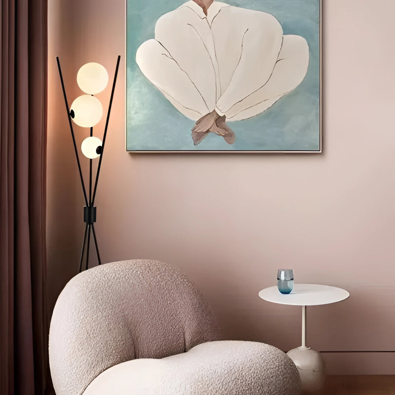 Modern LED moonlamp providing ambient lighting in a living room setting, featuring a white lamp on a wooden floor with textile accents and comfortable interior design elements.