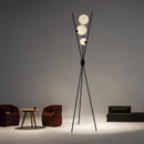 Modern LED Moonlamp floor lamp in a living room setting with wooden furniture including a chair and table, featuring artistic lighting and shades.