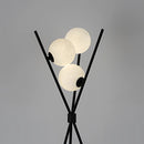 Modern LED Moonlamp designed as a sphere on a metal pole, resembling a street light, with artful tree silhouettes against a sky background, enhancing living room ambiance.