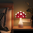 Warm white LED mushroom table lamp displayed on a wooden table enhancing the cozy, artistic interior design of the room.