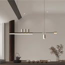 Modern LED pendant light with a Nordic-inspired sleek design, displayed in an interior setting featuring a rectangular shade, wooden floor, houseplants in flowerpots, and grey flooring.