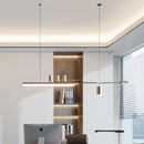 Sleek Nordic-inspired LED pendant light hanging over a wooden table in a room with stylish cabinetry, shelving, and bookcase.