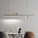 Nordic-inspired sleek LED pendant light featuring a grey rectangular lamp above a wooden table, complemented by comfortable interior design elements including shelving and wall materials.