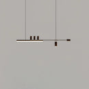 Matte black LED pendant light with a Nordic-inspired sleek design, featuring a rectangular shape and cool lighting, displayed against a wooden background.