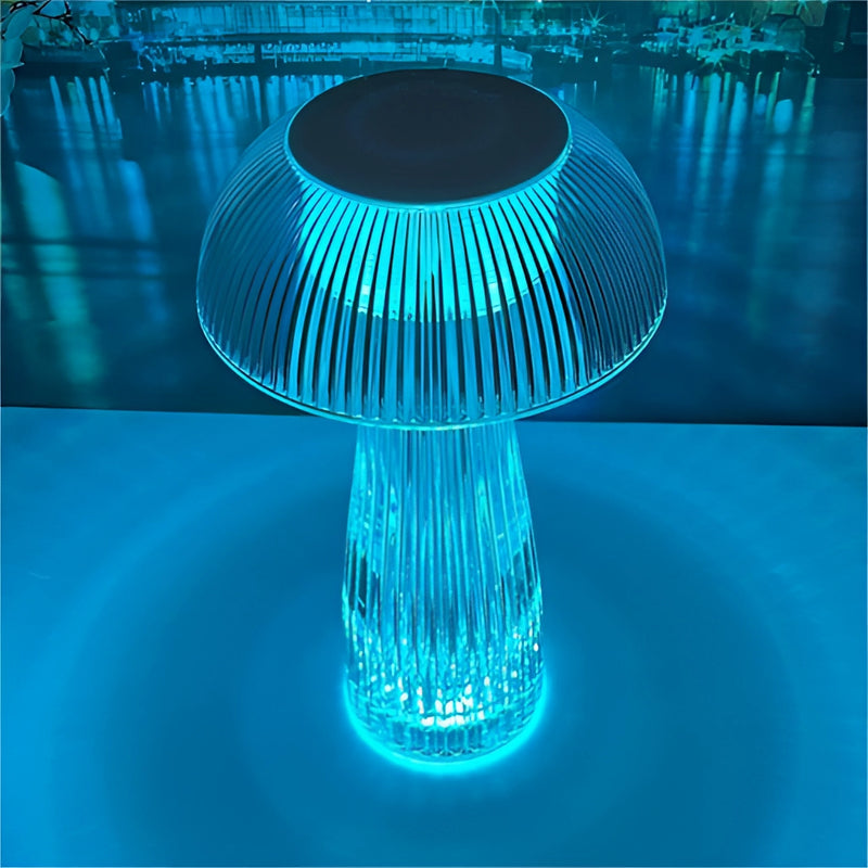 LED table lamp featuring steepless dimming, displayed on a blue-themed table setting with artistic elements and a background of trees and water.