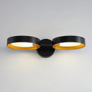 Contemporary iron and acrylic LED wall light with an artistic design.