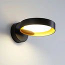 Contemporary iron and acrylic LED wall light featuring an artistic circular design with ring and cylinder elements, resembling jewellery.