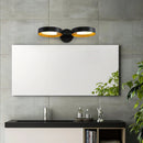 Contemporary LED wall light featuring an artistic iron and acrylic sconce mounted above a sink in a modern bathroom with white cabinetry.