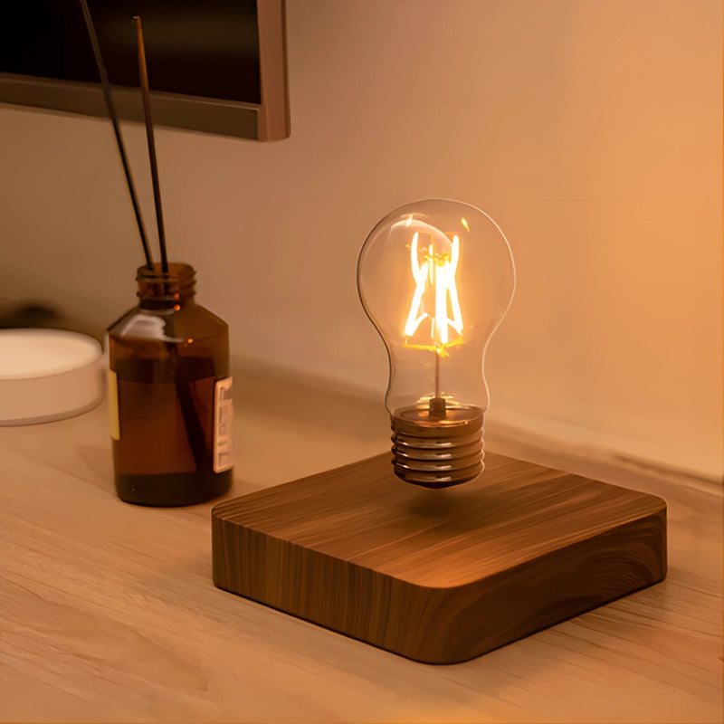 Levitating LED desk lamp with a glowing rectangular light and a walnut wood base on a table, showcasing a stylish interior design.