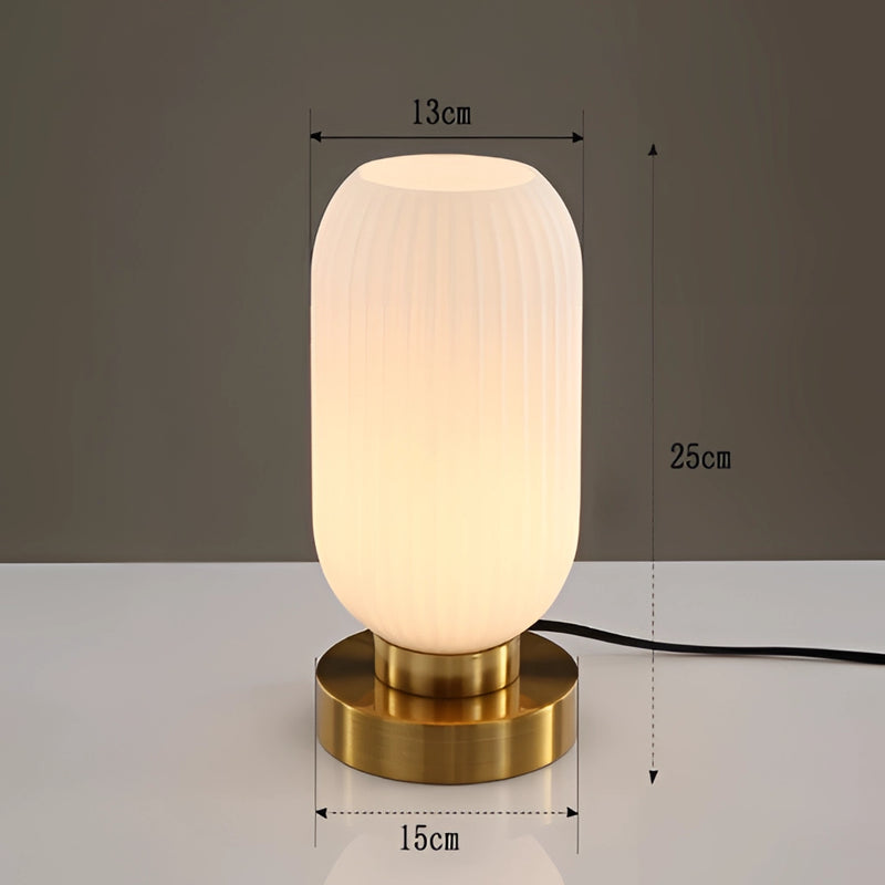White luminescent crystal table lamp, 13cm size, featuring a cylindrical shape with a fluorescent glow, positioned on a wooden surface.