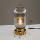 Smoky gray luminescent crystal table lamp featuring a transparent glass body with metal and aluminum accents, designed to resemble a small, elegant tower light fixture.