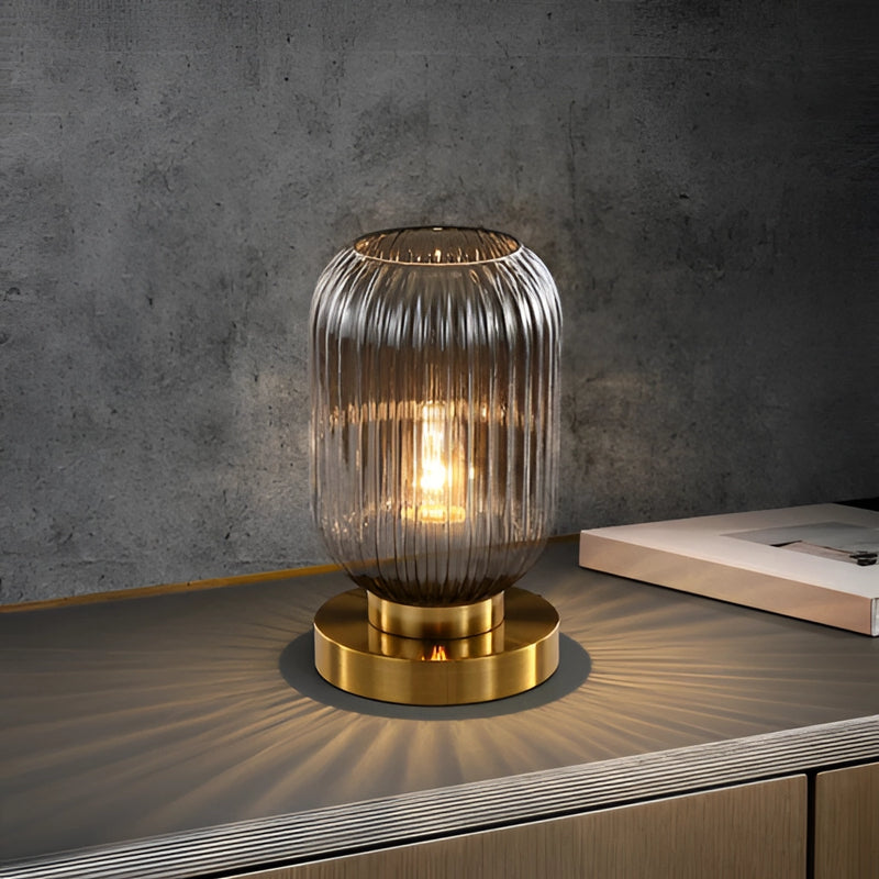 Crystal table lamp featuring a blend of glass, metal, and wood, artistically crafted into a luminescent light fixture with intricate design elements resembling a sculpture.
