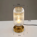 Bernstein luminescent crystal table lamp with metal details and a glass body, illuminated to showcase its elegant design.