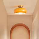 Interior view featuring a Jaxon Glass Pendant Light, a luxury modern style chandelier with LED bulbs, hanging from a plaster ceiling over hardwood flooring, enhancing the orange tints and shades in the room.