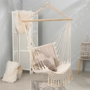 White macramé hammock swing made with composite materials, displayed in a garden setting, emphasizing comfort and artistic design.