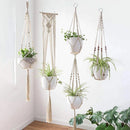 Set of 4 handcrafted macrame plant hangers featuring natural wood branches and rectangular hardwood accents, ideal for displaying houseplants and flowers in bohemian style.