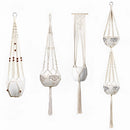 Set of four handcrafted macrame plant hangers in bohemian style, displayed artistically with intricate designs.