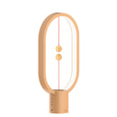Wooden magnetic balance table lamp with LED lighting, featuring a rectangular design and metal accents.