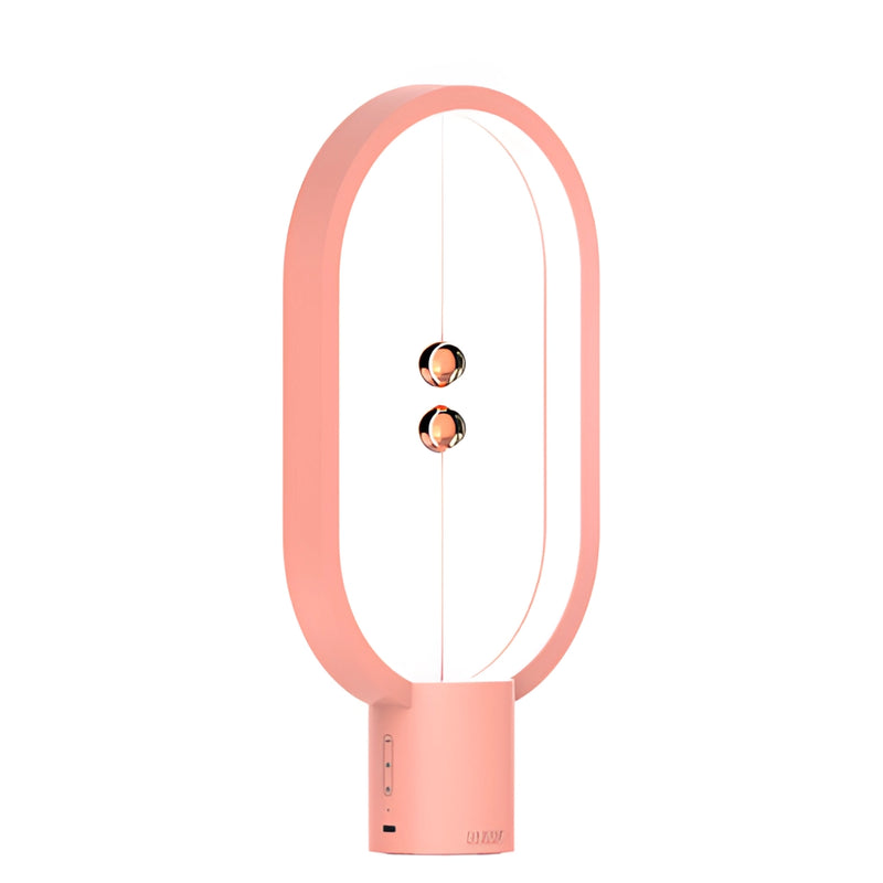Magenta Magnetic Balance Table Lamp with LED Lighting in Rosa variant, featuring a unique circular and rectangular design with prominent branding graphics.