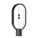 Black Magnetic Balance Table Lamp with LED Lighting featuring a sleek design with a unique balance mechanism.