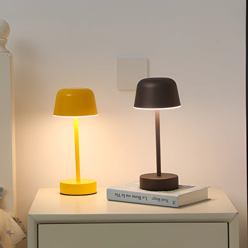 Adjustable metal table lamp from the Pulse Flare series, featuring a grey color scheme, positioned on a wooden shelf with soft interior lighting enhancing the ambiance.