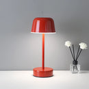Red Metal Table Lamp with Adjustable Brightness - Pulse Flare, featuring a lampshade, glass accents, and petal designs on a rectangular table.