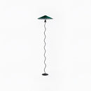 Teal curved pleated floor lamp with a metal pole and artistic light fixture design.