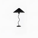 Black table lamp with a curved, pleated metal textile shade, featuring a sleek design suitable for indoor use.
