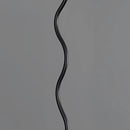 Curved pleated metal floor lamp with a design resembling a scaled reptile tail as a fashion accessory.