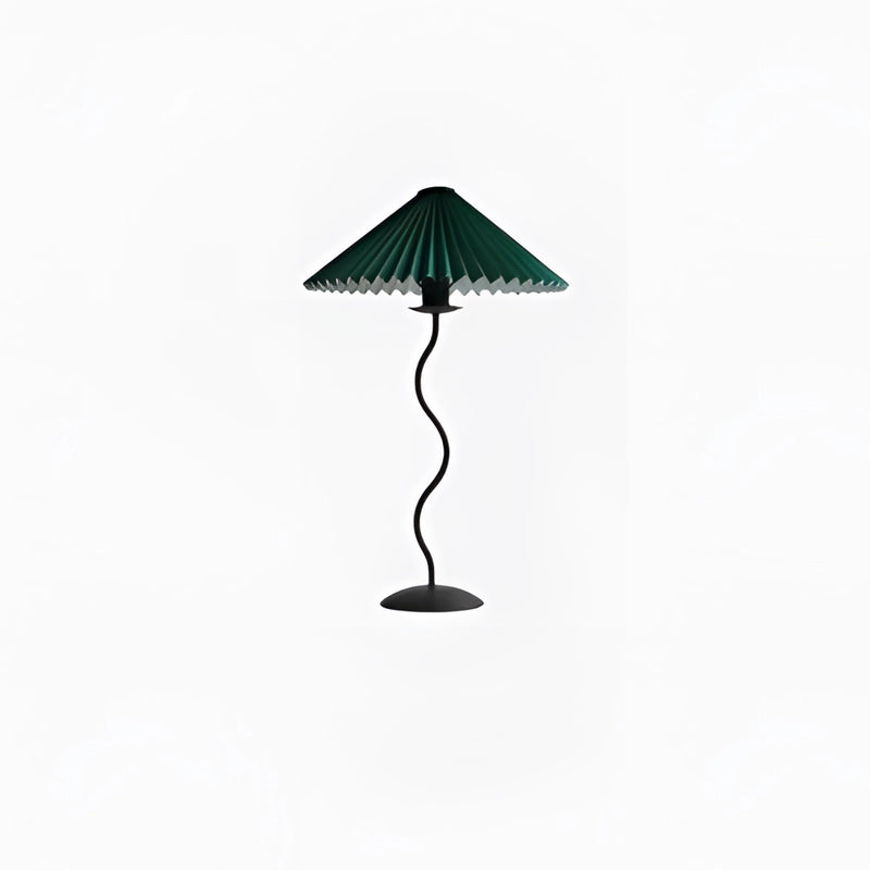 Teal table lamp with a curved, pleated metal textile shade, accompanied by a plant, providing a balanced and stylish light fixture.