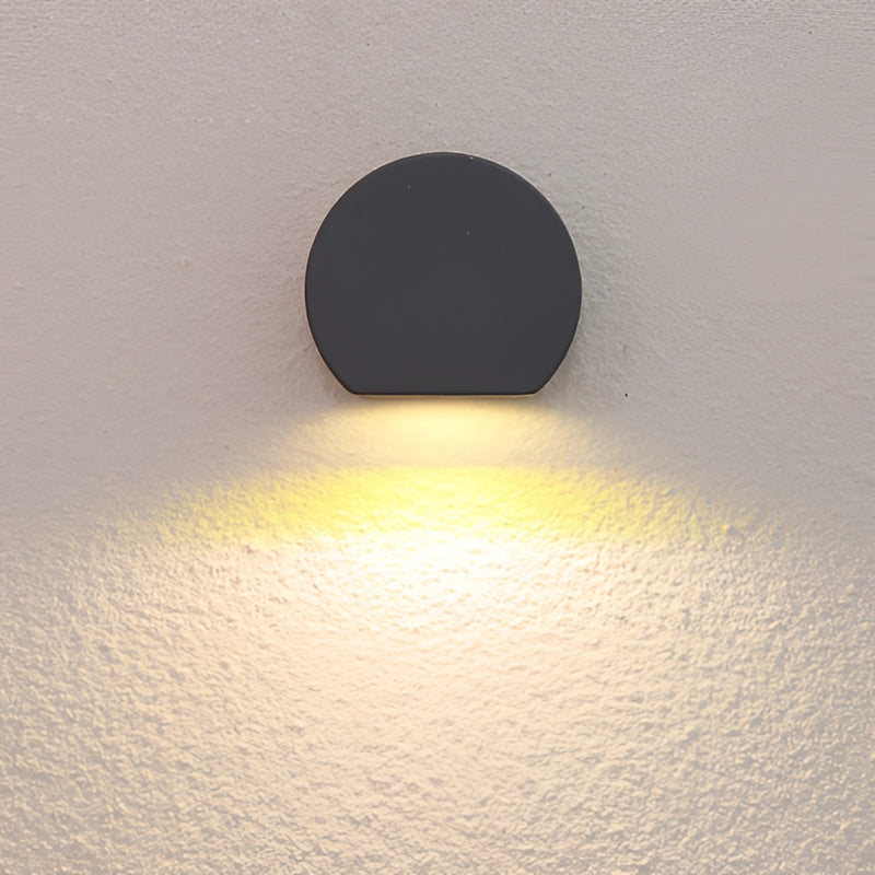 LED wall lamp designed as a metal sconce in sand black and grey, featuring aluminum and borosilicate glass components, styled in a minimalist aesthetic.