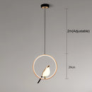 Modern rotatable wall sconce with a 360-degree circular gold lampshade emitting warm light, mounted on a ceiling.