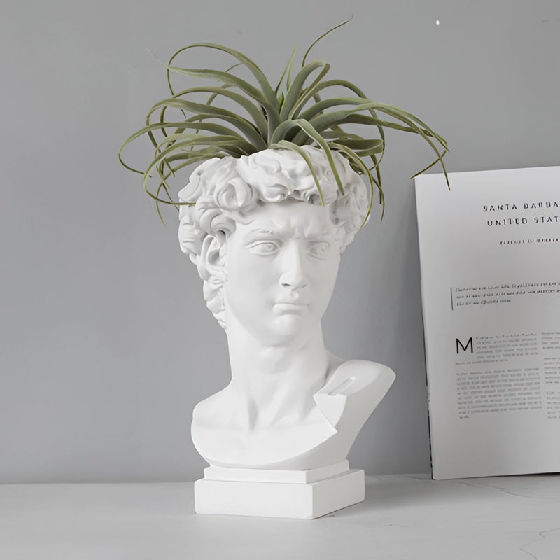 Neoclassical Greek head-shaped resin vase featuring plant, styled as a statue or sculpture, highlighting artistic and sculptural elements.