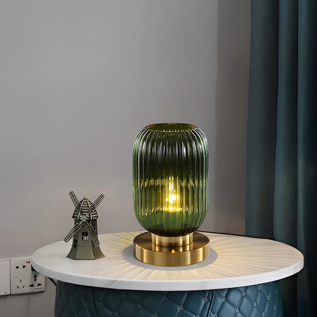 Nordic Amber Table Lamp with a stained glass shade featuring a cylindrical metal base and composite materials, set on a desk in a room.